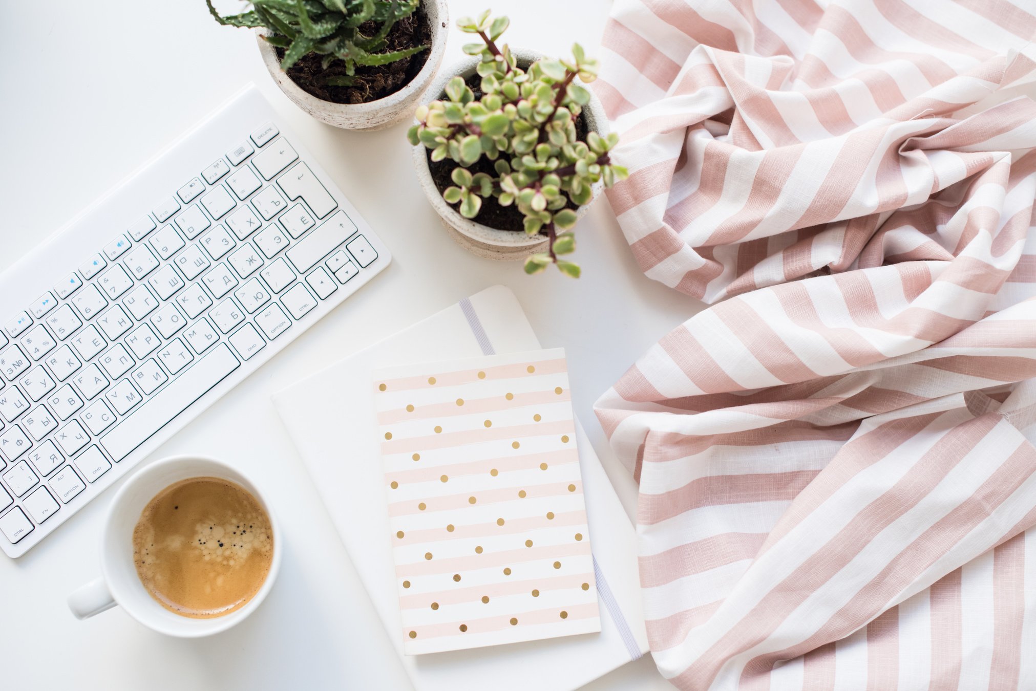 Minimalist Flat Lay of Feminine Work Space with Plants, Coffee and Journals